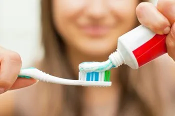 woman holding toothbrush